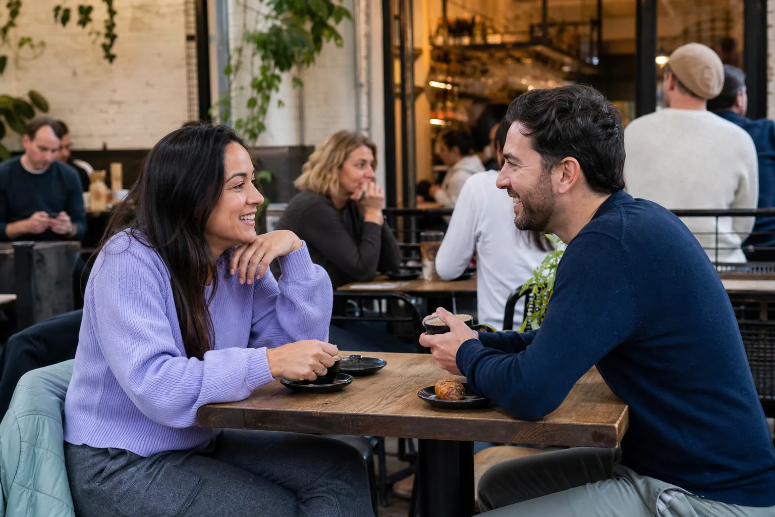 Two people chatting over coffee in Leamington Spa town centre